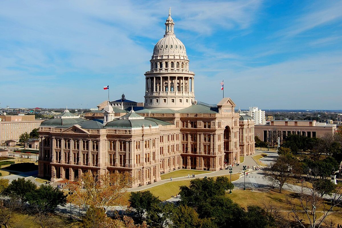 the Texas Capitol building and grounds with spring flowers blooming