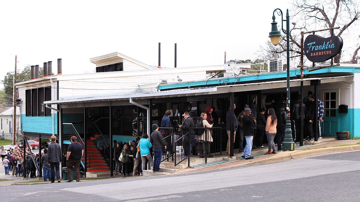 line of customers outside Franklin Barbecue on East 11th Street in Austin Texas on a weekday morning